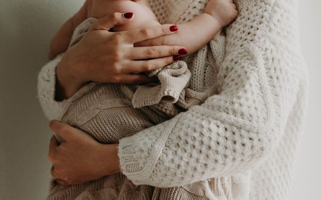 parent with newborn in hands